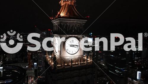 Aerial Night View Of The Palace Of Culture And Science Near Downtown Business Skyscrapers In The City Center.