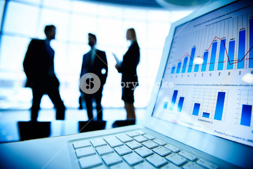 Financial Document In Laptop On Background Of Three Business Partners Interacting