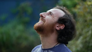 Skyward Gratitude: A Grateful Man Smiling At The Sky With Hope And Faith, Standing Outdoors And Looking Upward With Thankful Contemplation